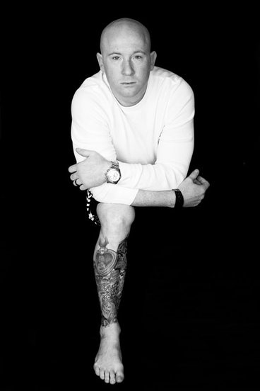 Man poses with memorial leg tattoo