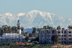 The LMU Westchester campus in winter under the snow-capped San Gabriel Mountains.